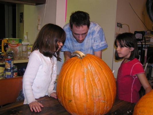 David carves up the other pumpkin the traditional way.