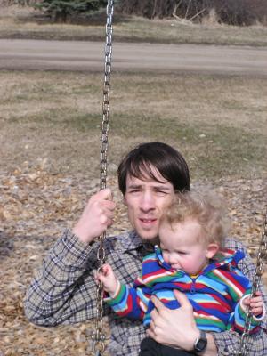 David and Noah on a swing.