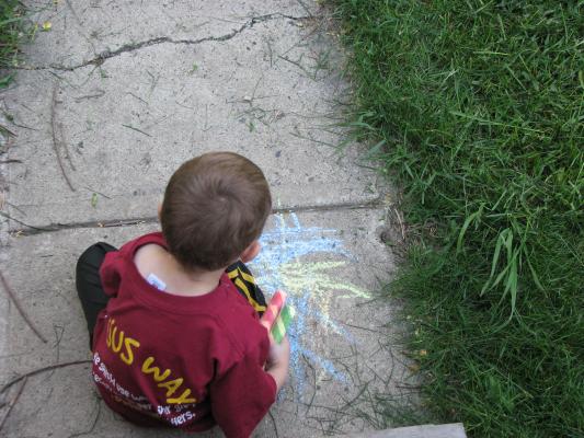 Noah plays with chalk.