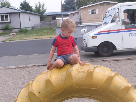 Noah on a tire at the park