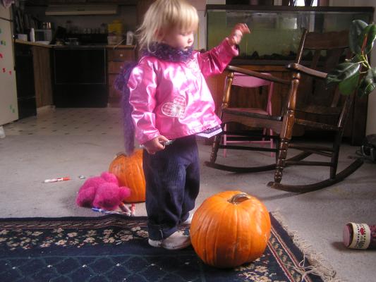 Sarah plays with a pumpkin
