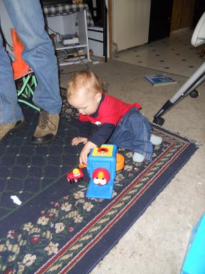 Joshua has a little car from Grandma and Grandpa Eder and Elmo-in-the-box. 