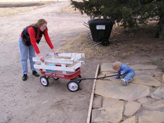 Noah pulls his ball in the wagon.