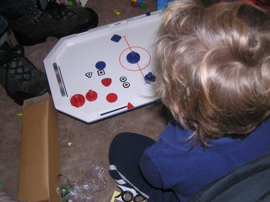 Noah plays with his air hocky table from Santa,