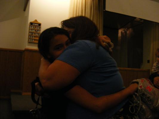 Malia hugs her grandma after being baptized.