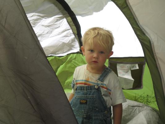 Noah looks out the tent.