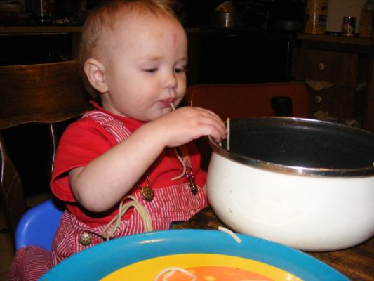 Joshua eats spaghetti from a pan 