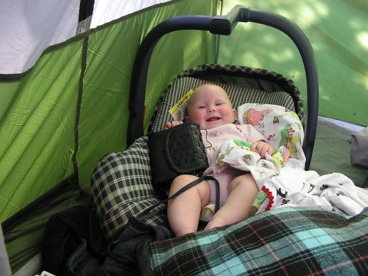 Sarah wakes up from her nap in her carseat in the tent.