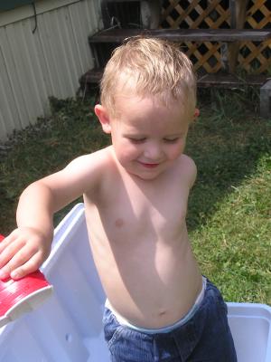 Noah dumps water in the cooler.