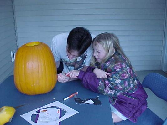 Stephanie and Robert carving a pumkin