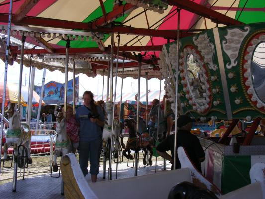 Katie helps Sarah on the Carousel at the fair.