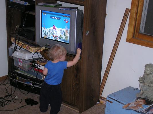 Noah watches a skiing game on the Play Station 2.