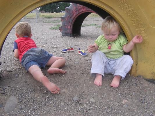 Noah and Sarah in a tire at the park