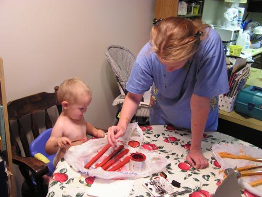 Katie and Noah are painting sticks for picture frames.