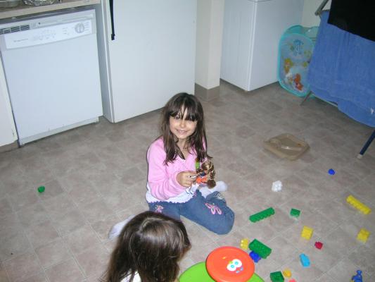 Malia and Andrea see how many toys they can put on the floor at the same time.