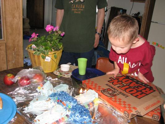 4-year-old Noah blows out his candles.