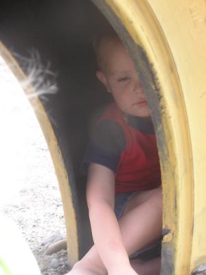 Noah in a tire at the park.