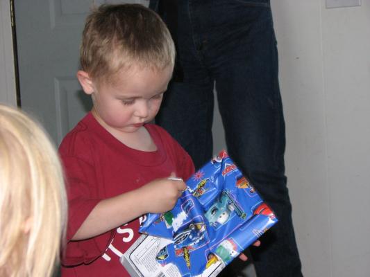 Noah opens a gift from Grandma.