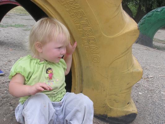 Sarah in a tire at the park