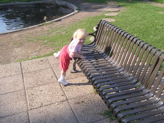 Sarah climbs a park bench