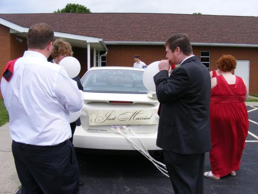 Titus, Shane and others decorate the car.