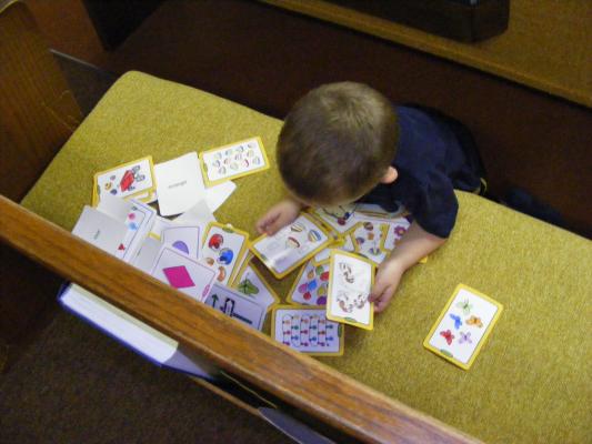 Noah plays with some cards that were a gift for Sarah in her flower-girl bag.