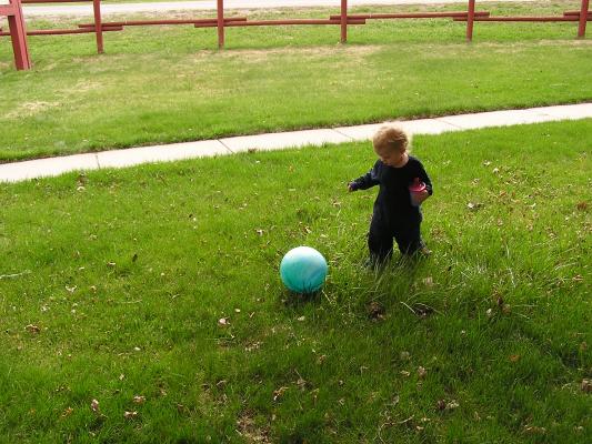 Noah plays with his blue ball.