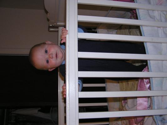 Sarah  can stand up in her crib.
