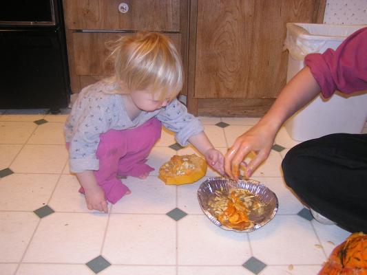 Sarah plays with the pumpkin guts.