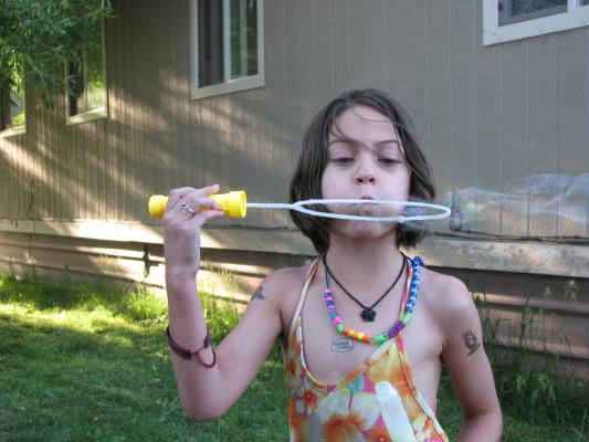 Andrea blows bubbles.
