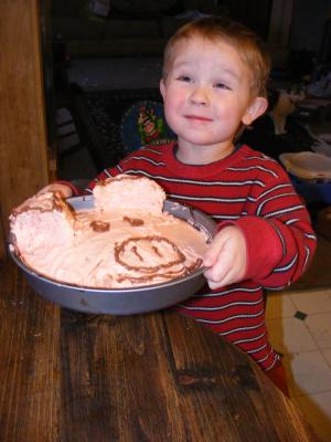 Noah holds a pigcake.