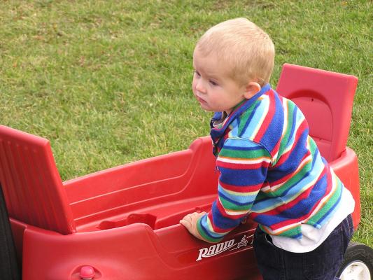 Noah gets out of the Radio Flyer wagon.