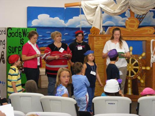 Katie E. gives out VBS awards.