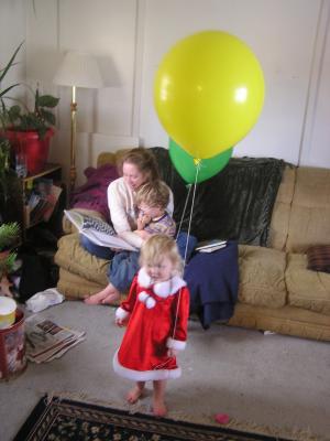Katie and Noah read a story. Sarah plays with a balloon