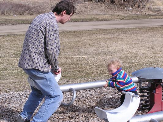 David and Noah play with the teetertotter.