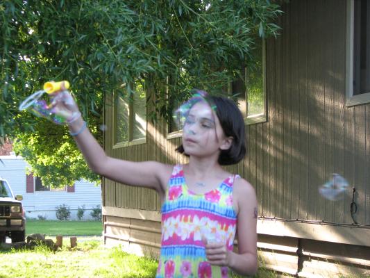 Malia blows bubbles.