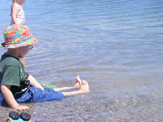 Noah looks at feet in Browns lake.