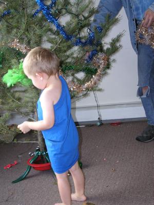 Noah and David decorate the Christmas tree.