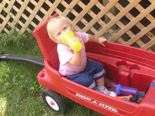 Sarah plays in the wagon.