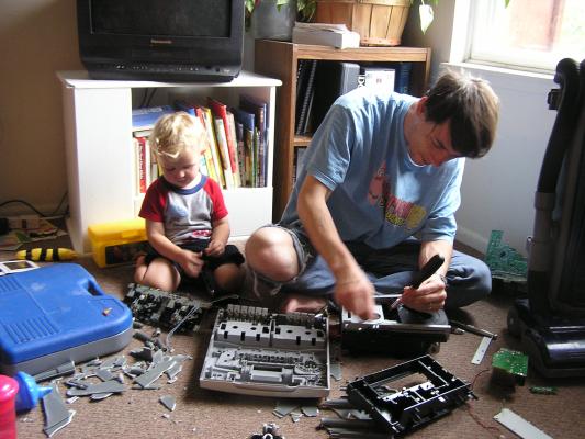 David and Noah take apart a broken stereo.