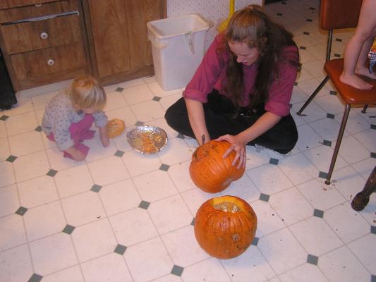 Sarah and Katie scoop out the pumpkins.