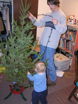 Noah and David decorate the Christmas tree.