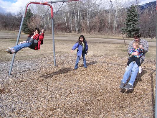 Andrea, Malia, David and Noah swinging.