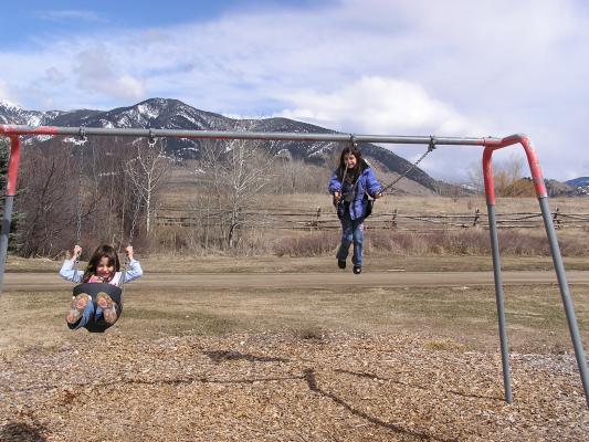 Andrea and Malia swing at East Gallatin Recreation Area.