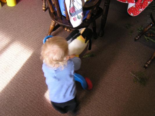 Noah pushes around his penguin.