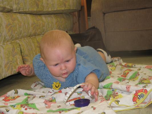 Sarah plays with Grandma's tape measure.