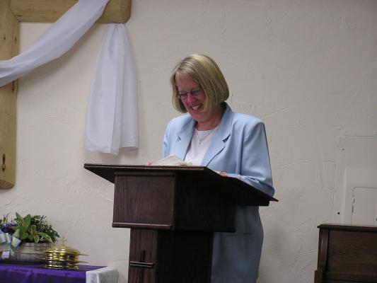 Debbie reads the morning scripture.