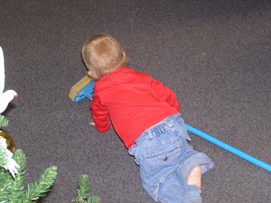 Noah gets on his hands and knees to help with the cleaning.
