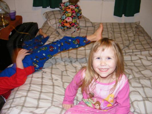 Silly kids on my bed. Noah's leg, Sarah, back of Joshua