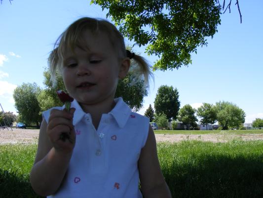 Sarah at the  park with a radish